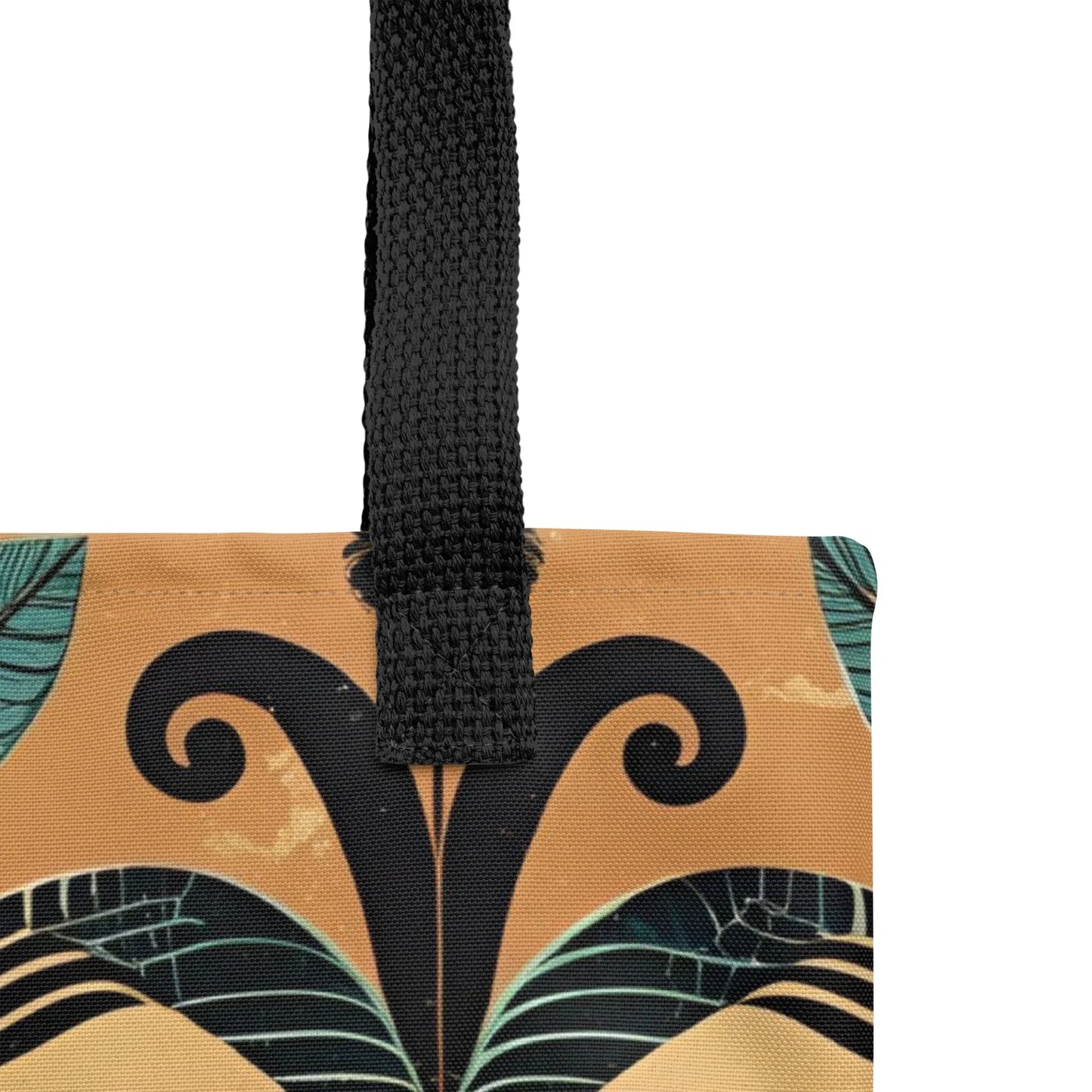 Minara Tote Bag - Close-up of a black handle of a Crete-inspired Minara tote bag with Mediterranean-style symmetrical pattern in teal, gold, and black, photographed against a rustic stone wall.