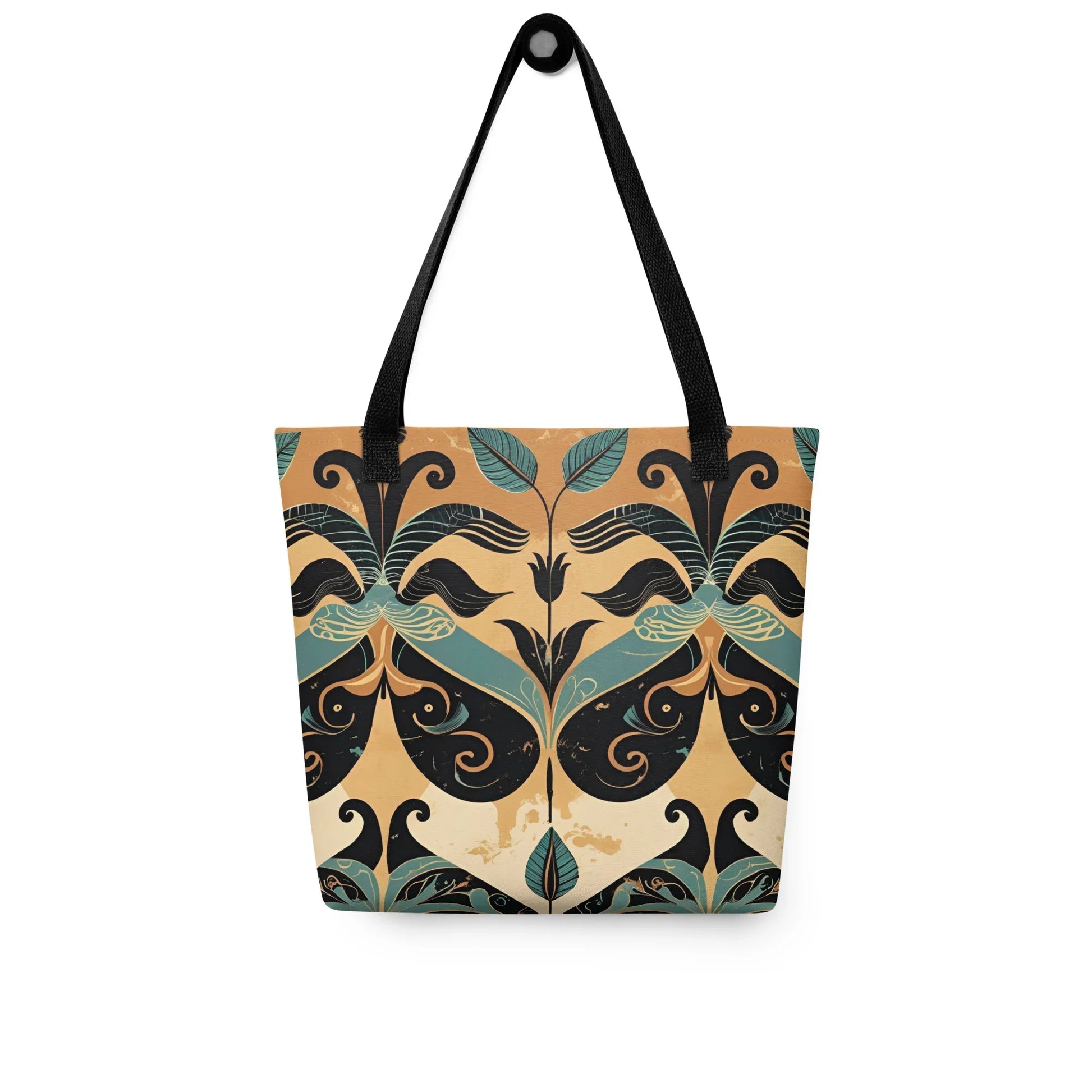 Minara Tote Bag - Crete-inspired Minara tote bag with Mediterranean-style symmetrical pattern in teal, gold, and black, photographed against a rustic stone wall.