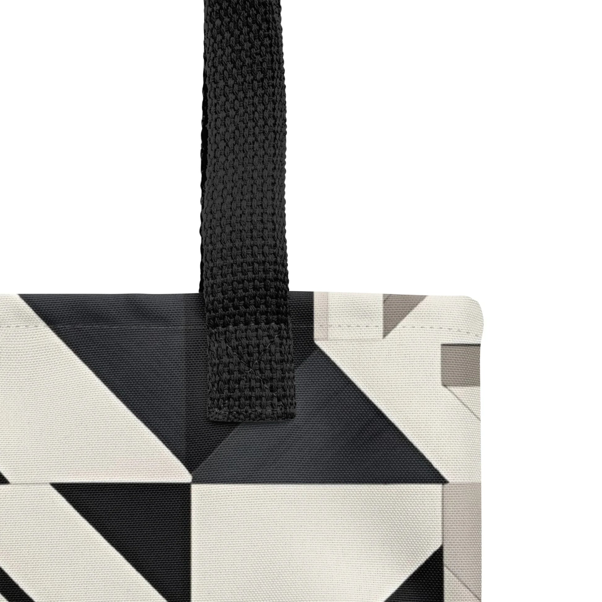 Deco Tote Bag - Close up of a black handle of A black and white KIND tote bag featuring geometric patterns in a stylish, Art Deco-inspired design; eco-friendly shoulder bag for everyday use.