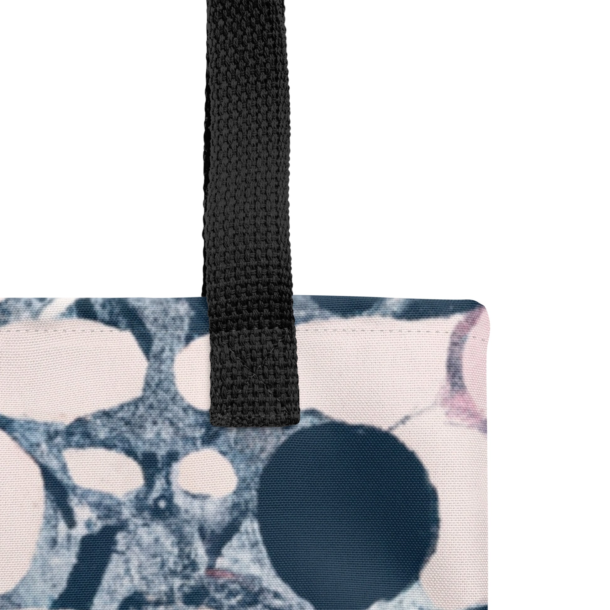 Close of black handle of Pink Tote Bag - A pink and blue KIND tote bag featuring abstract circles; eco-friendly shoulder bag for everyday use.